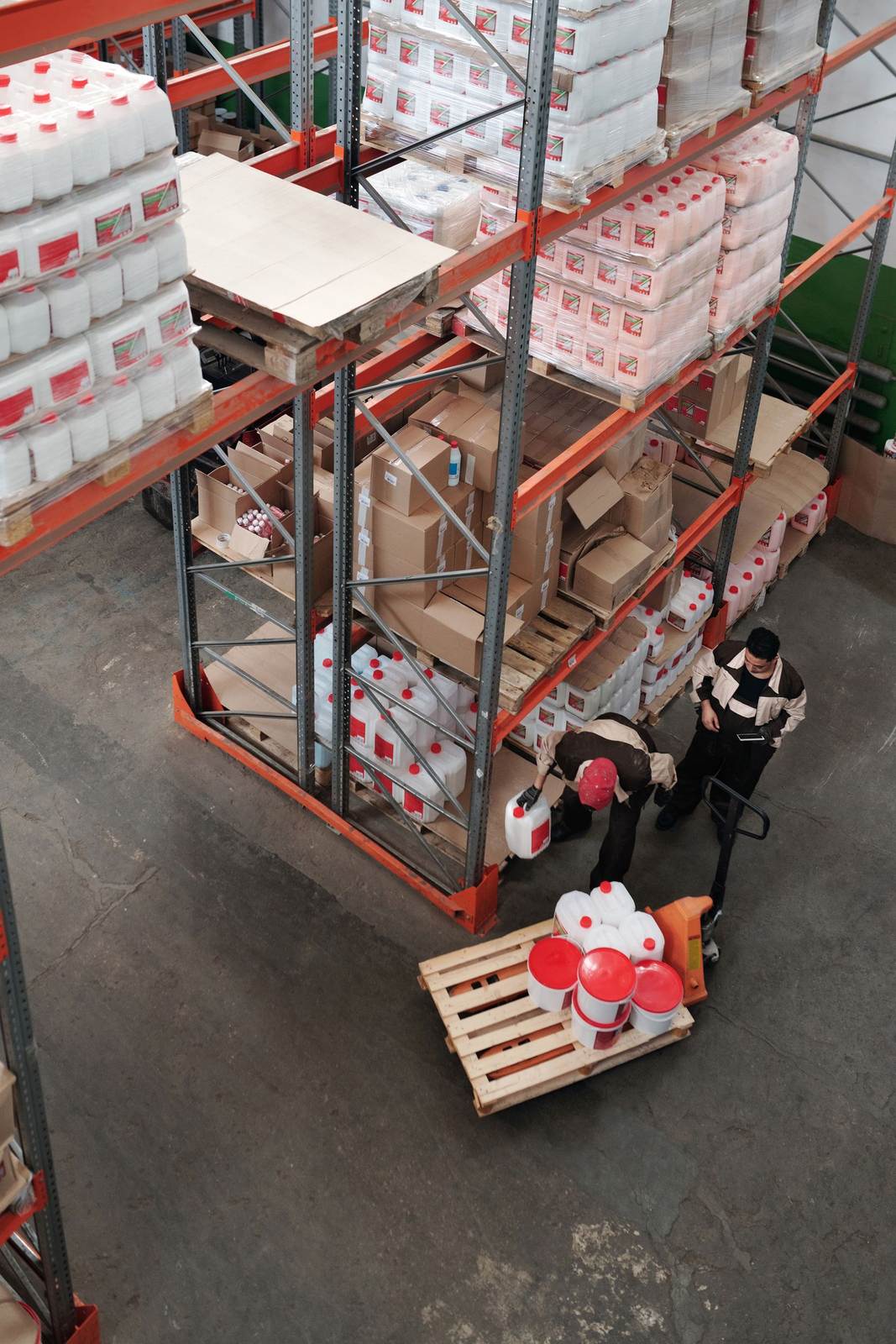 Warehouse workers organizing inventory on shelves, enhancing logistics efficiency